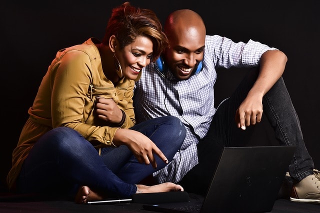 engaging content man and woman looking at computer