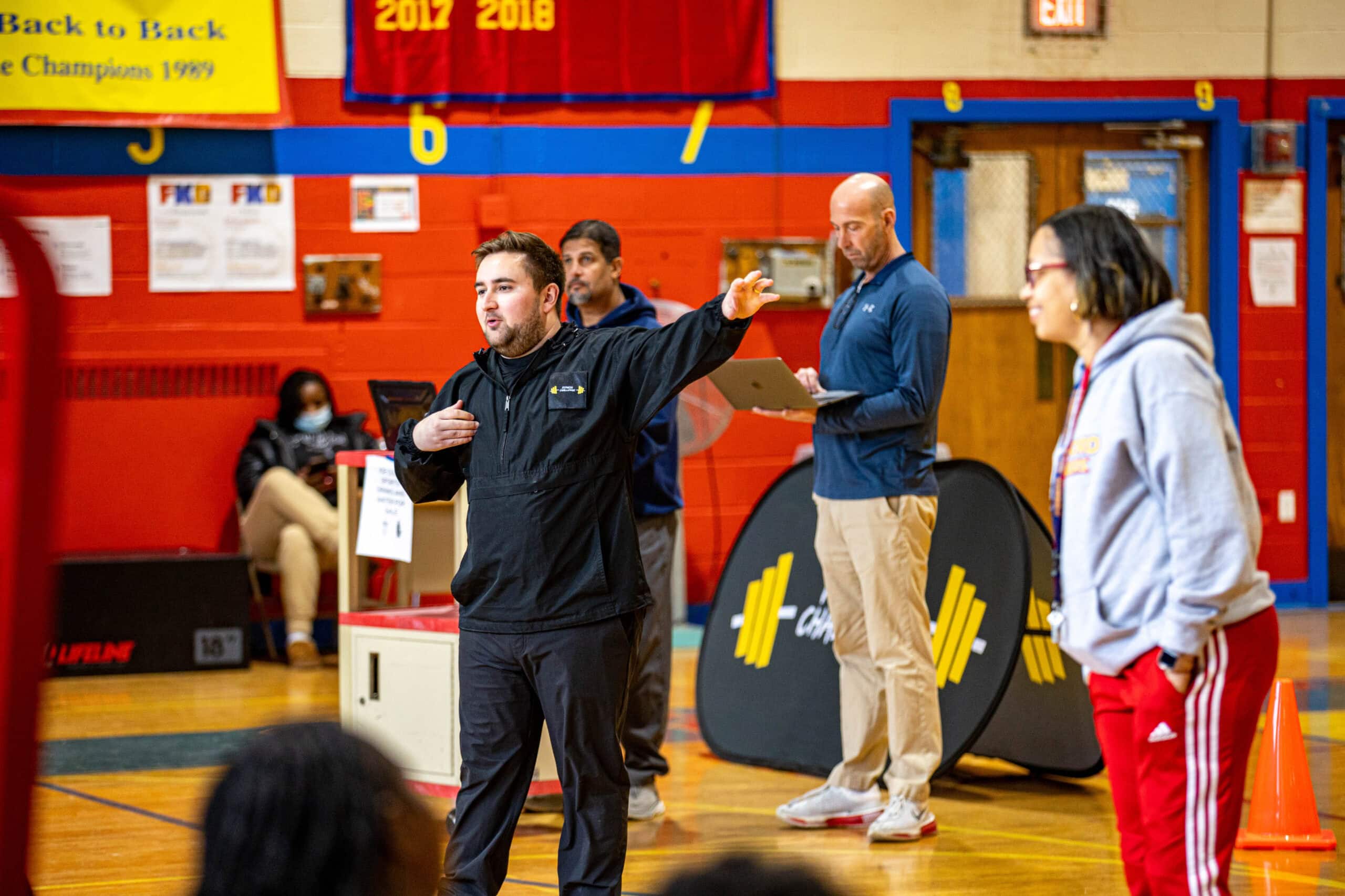 A guy instructing people what to do at a fitness event