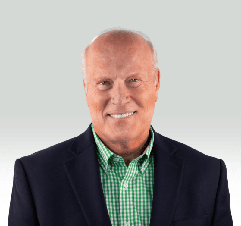 R.FORD A man with a green and white checkered shirt and a black jacket.