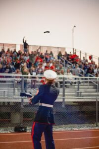 Marine throwing t-shirt into stands