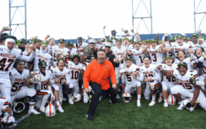 Excited Football team with coach in the middle
