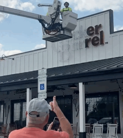 Construction Workers taking down New CB Logo