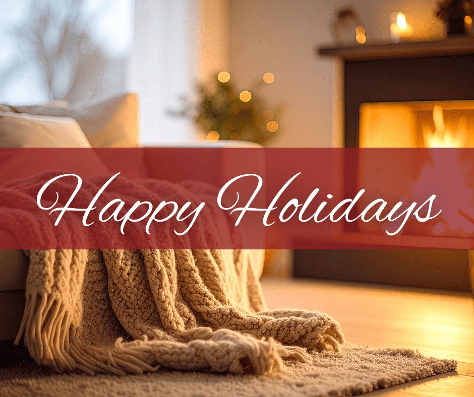 Happy Holidays text in front of cozy blanket and fireplace