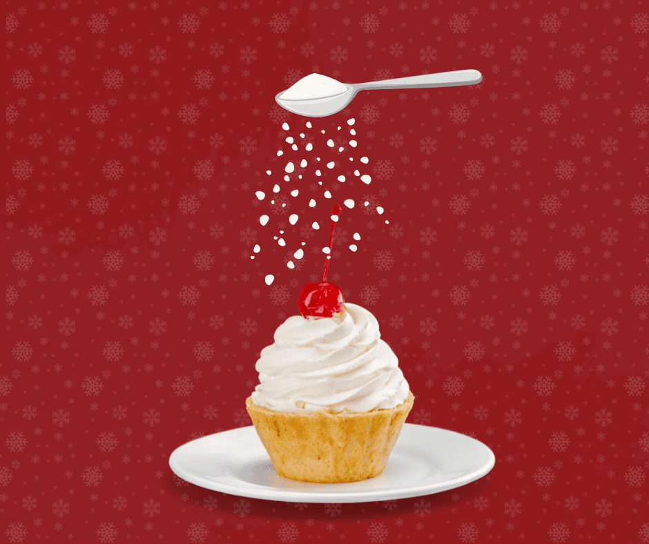 sugar being sprinkled on a cupcake