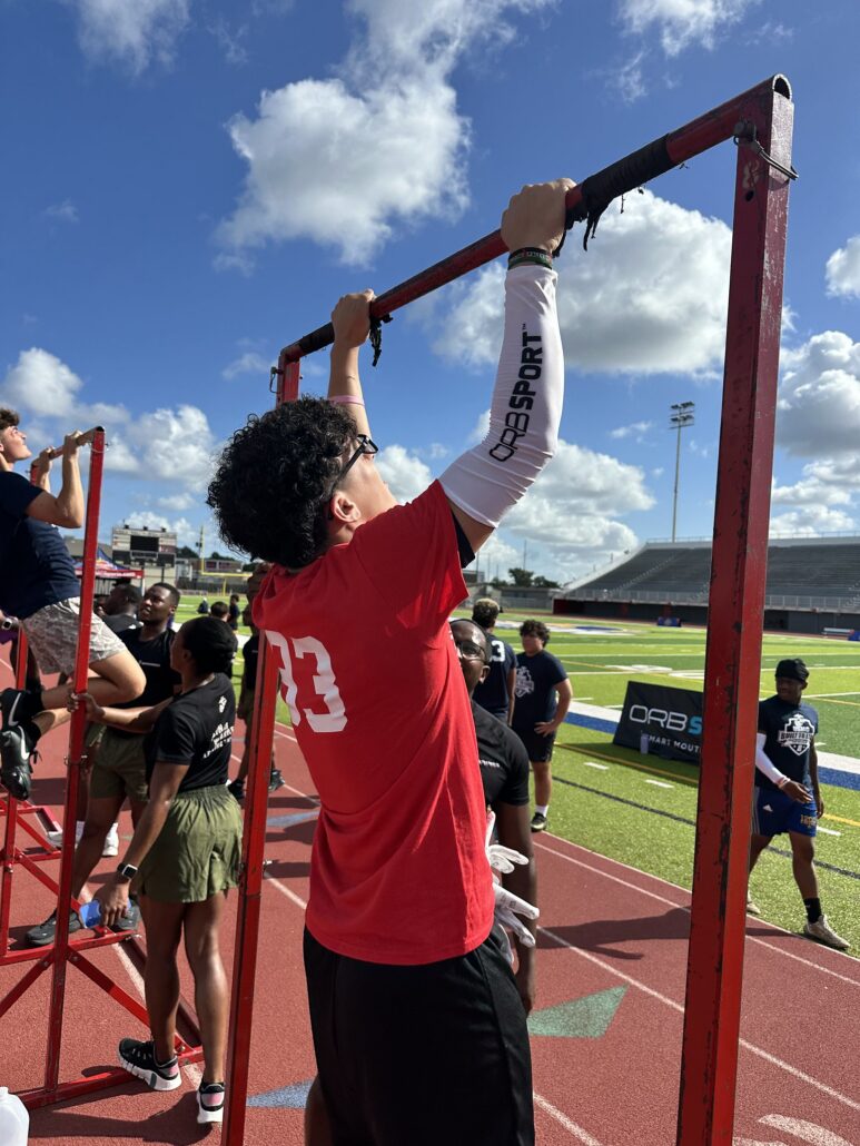 boy doing pull up on bar with ORB Sport Compression Sleeve