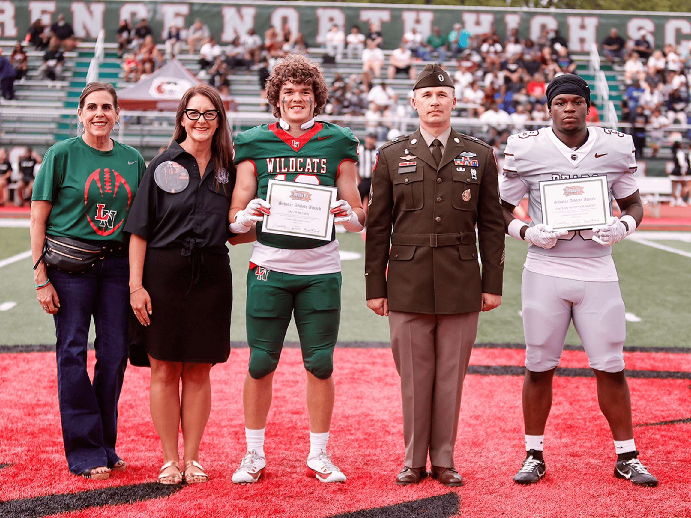 Scholar Athletes standing next to a Soldier and their families